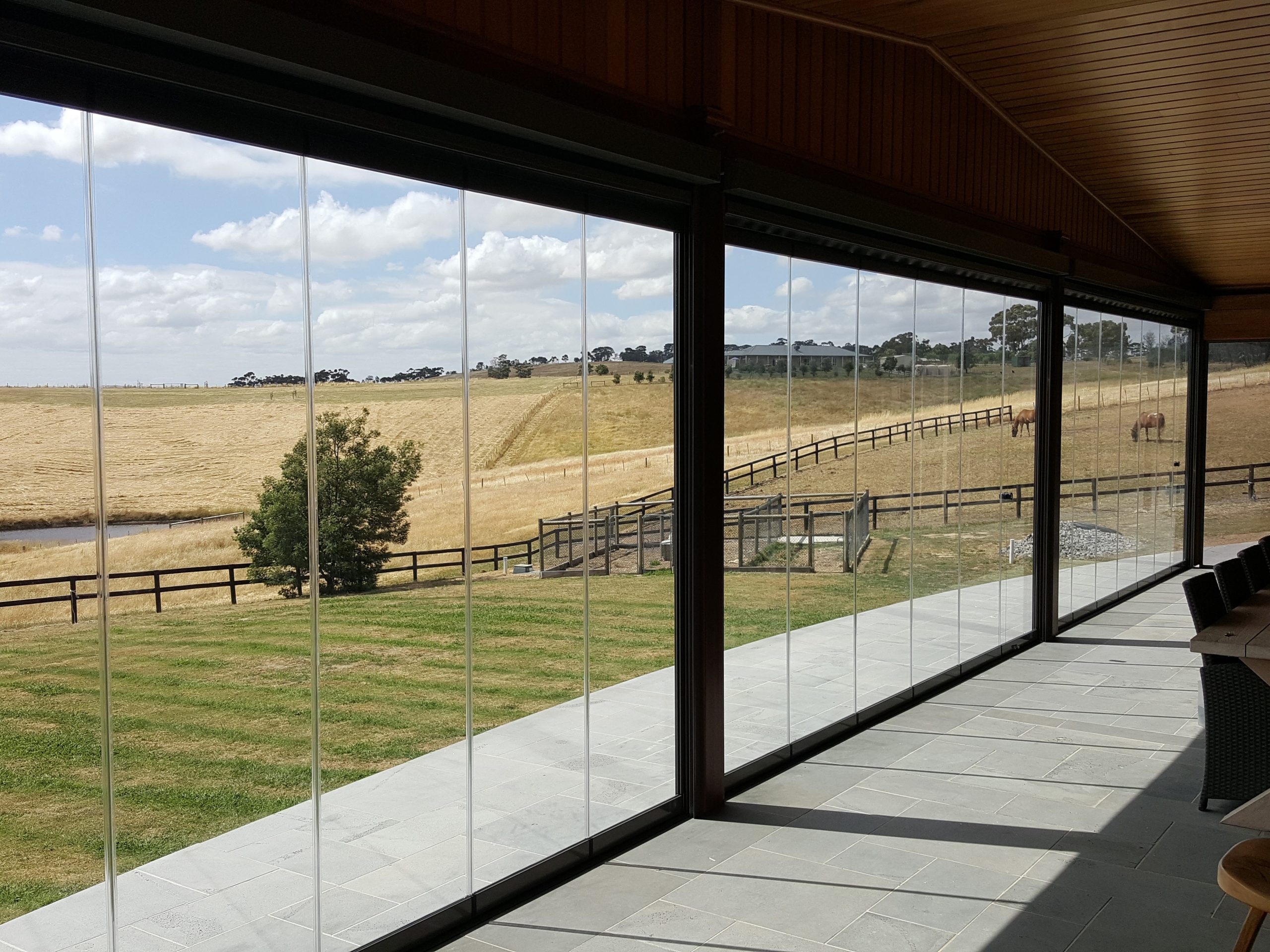 Glass enclosed alfresco looking over fields