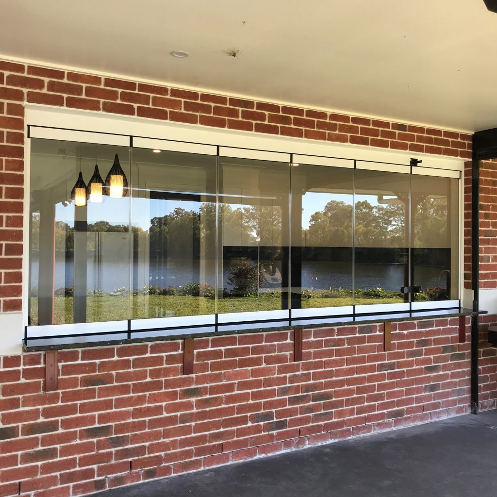 Glass servery windows into brick wall